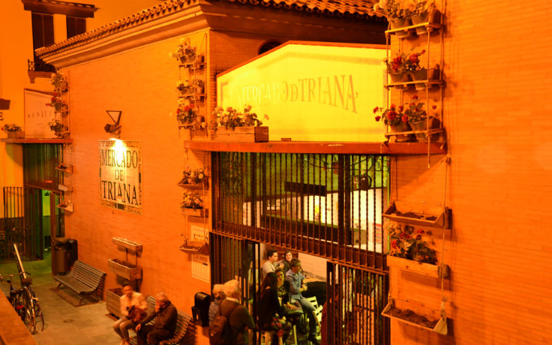 a group of people sitting outside of a building