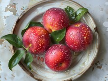 a plate of apples with leaves