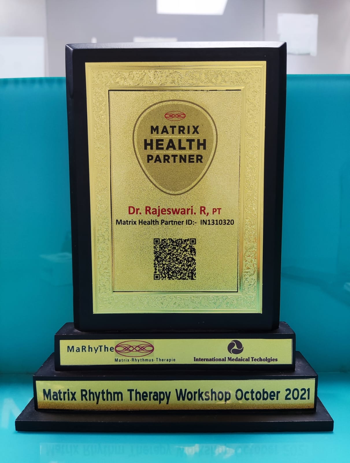 a gold plaque with a qr code on it