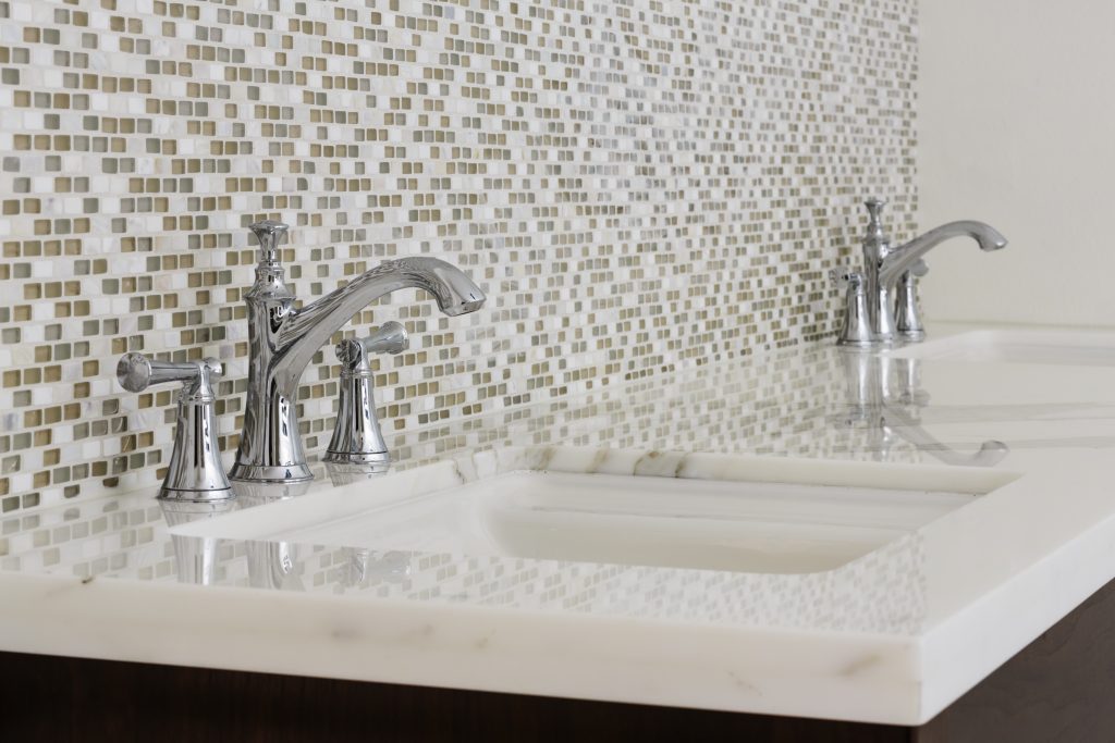 a bathroom sink with faucets