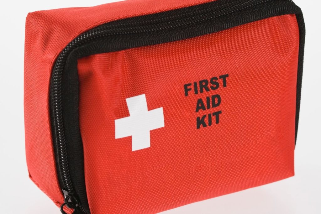 a red first aid kit with a white cross