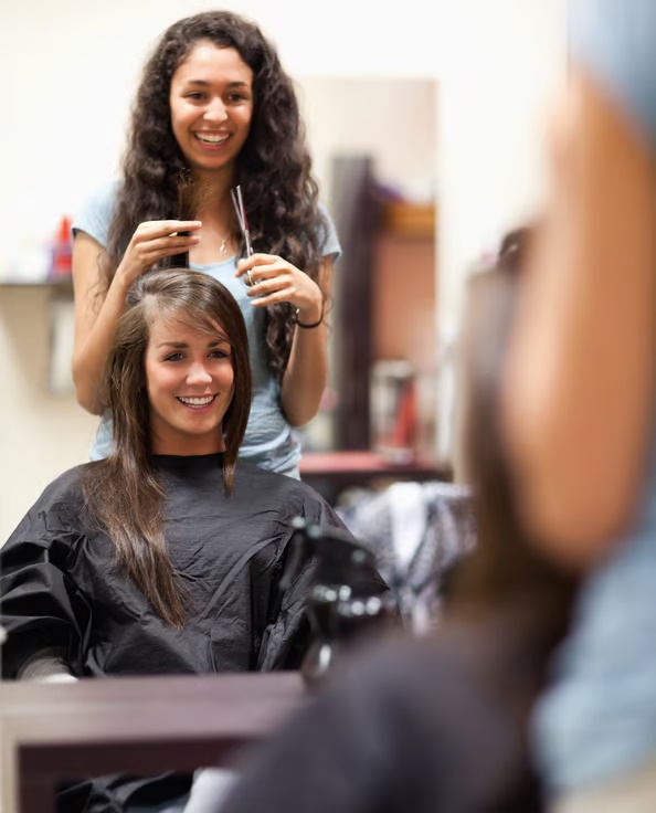 a woman getting her hair cut
