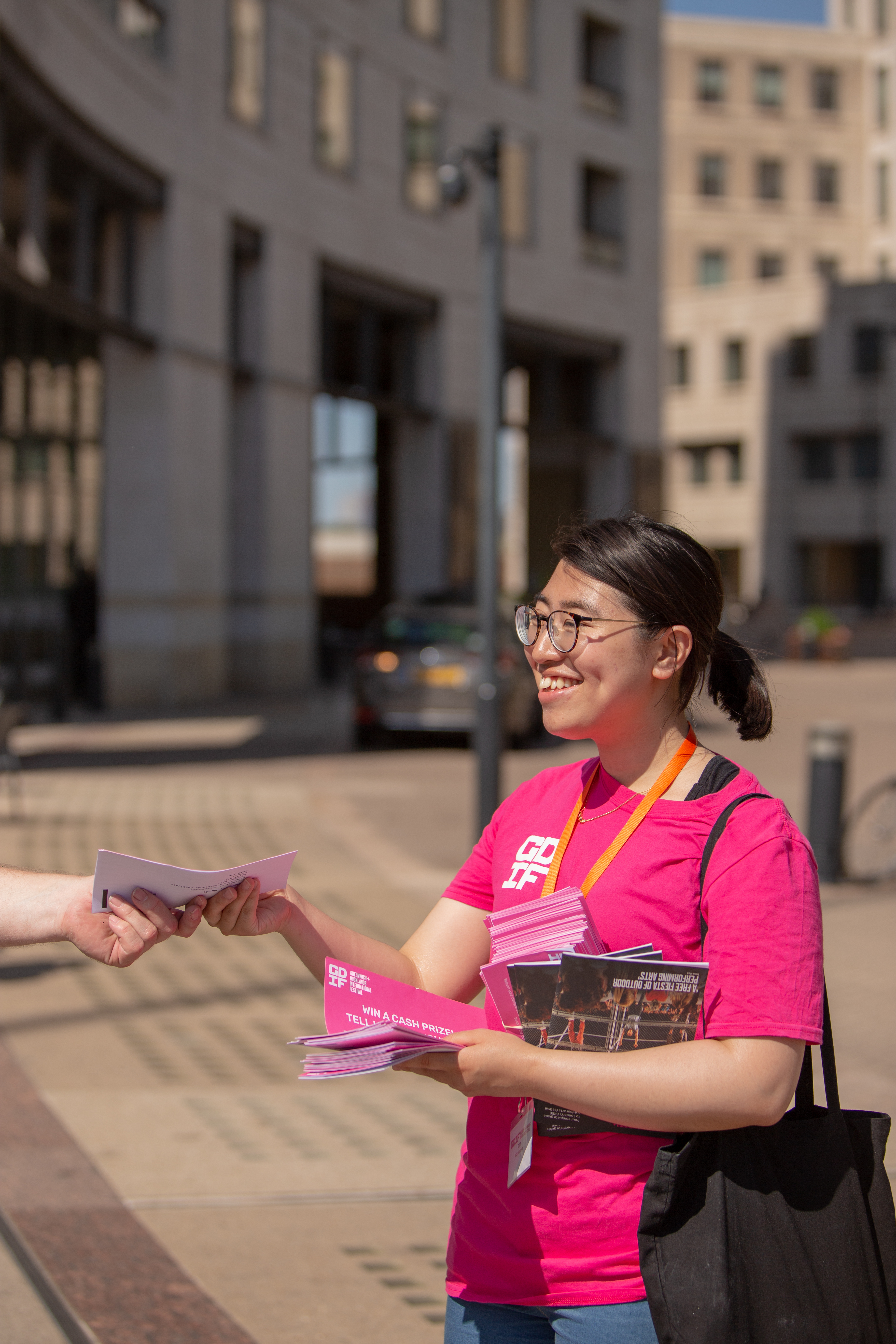 a woman smiling and holding books