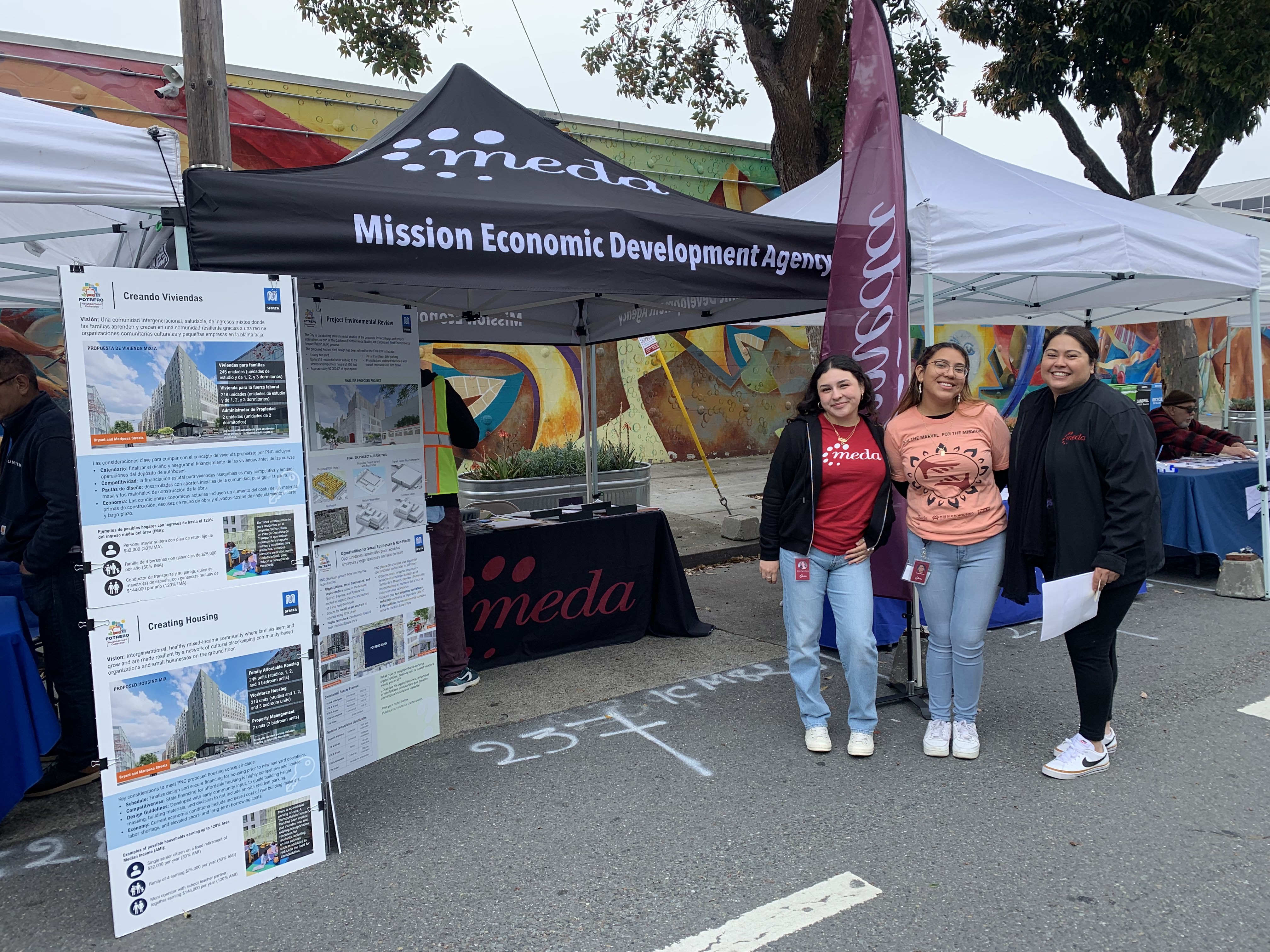 a group of women standing in front of a tent