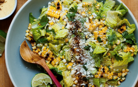 a plate of salad with a spoon