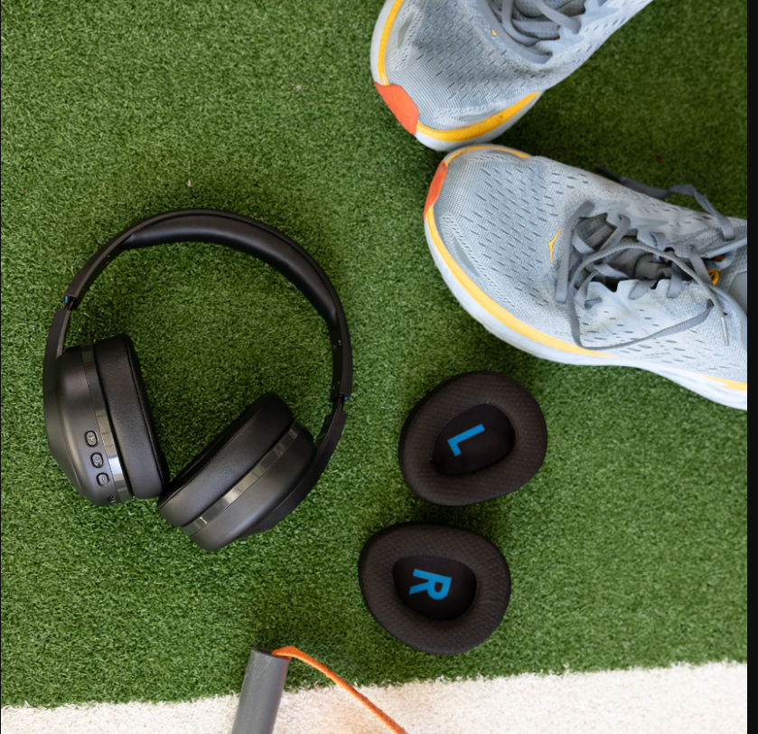 a pair of shoes and headphones on a green carpet