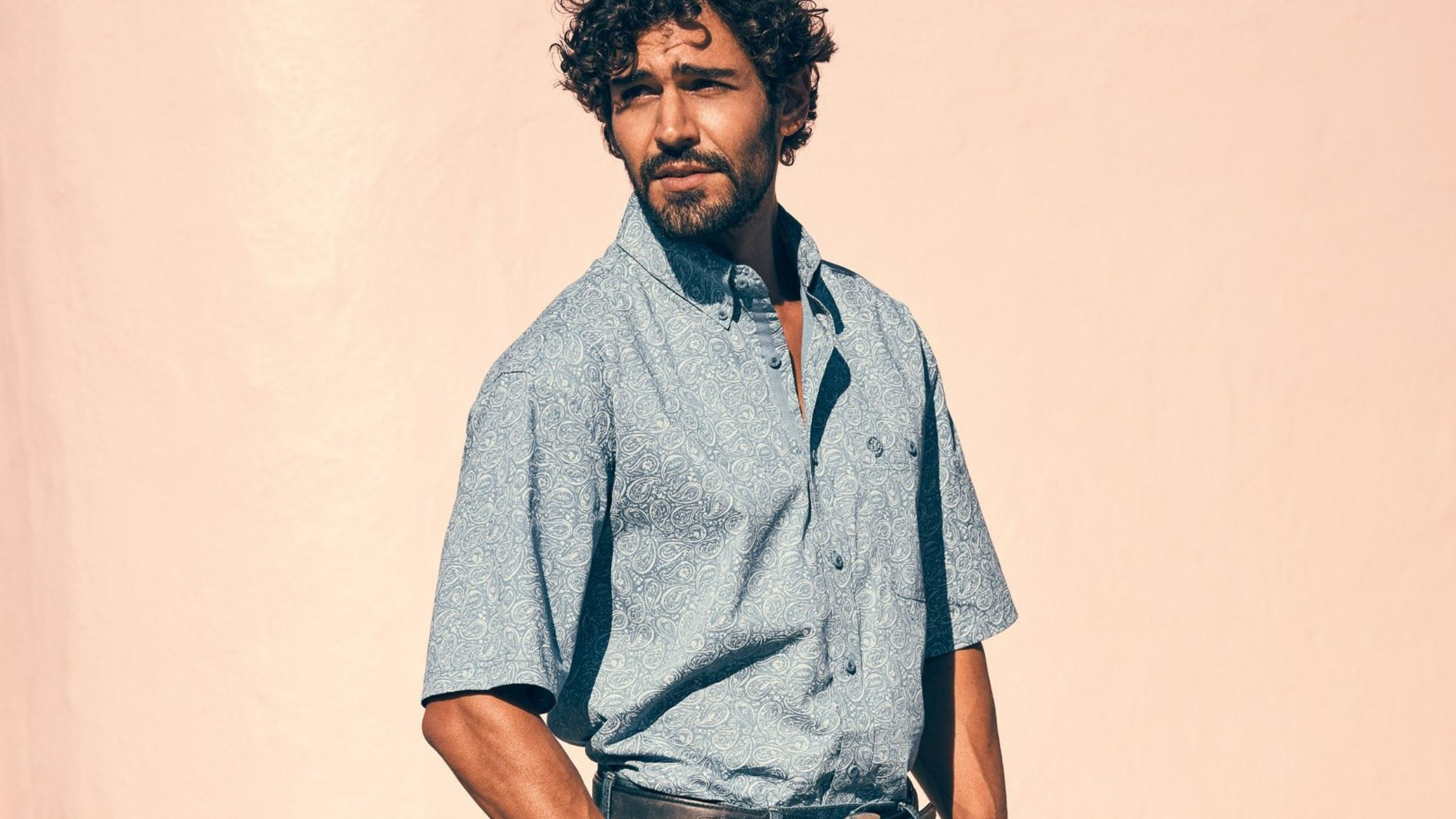 a man with curly hair and a beard