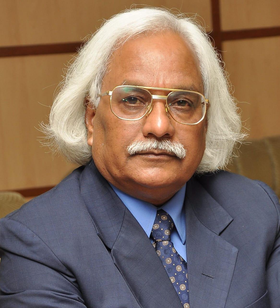 a man with white hair and glasses