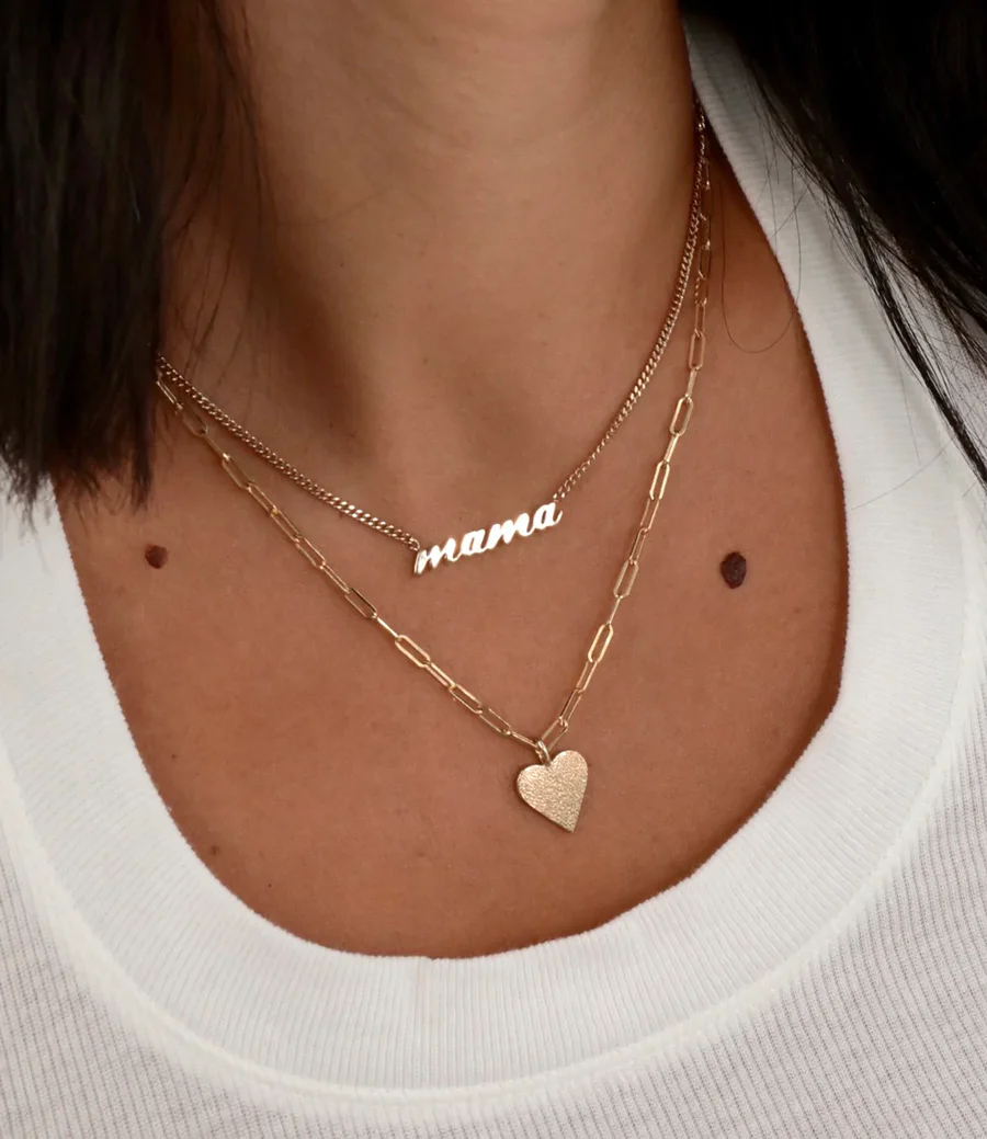 a woman wearing a white shirt and necklaces