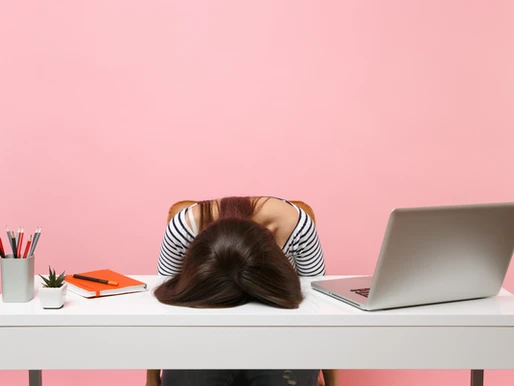 a woman with her head on a desk