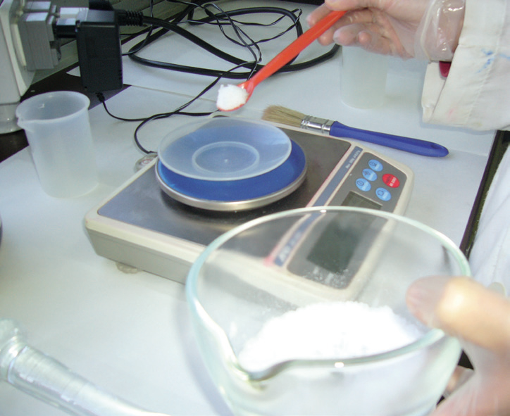 a person weighing a substance on a scale