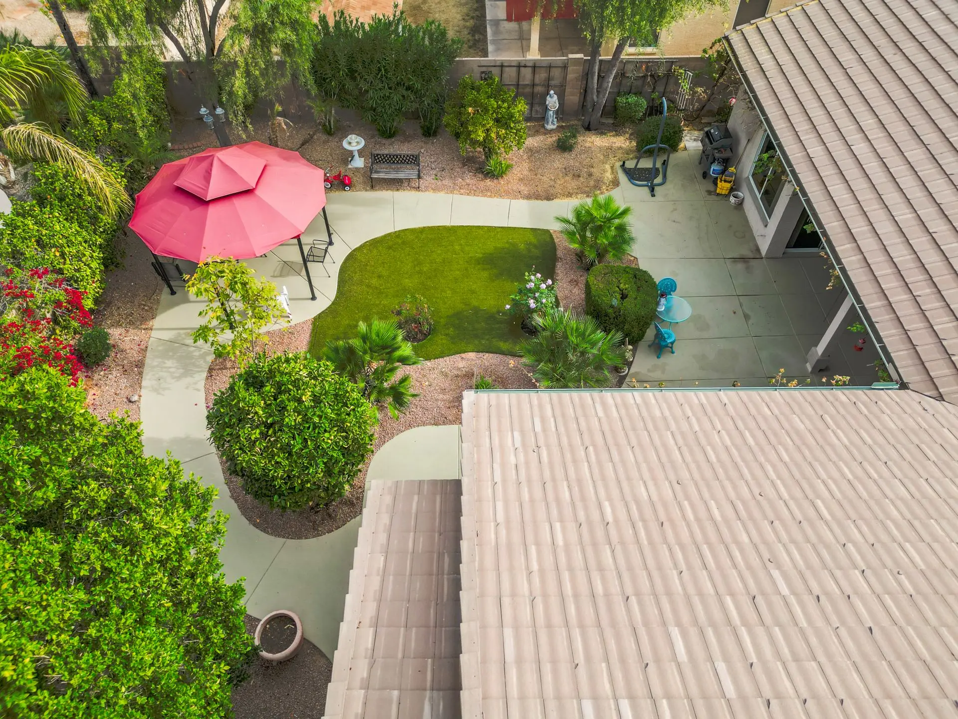 a view from above of a house with a patio and a lawn