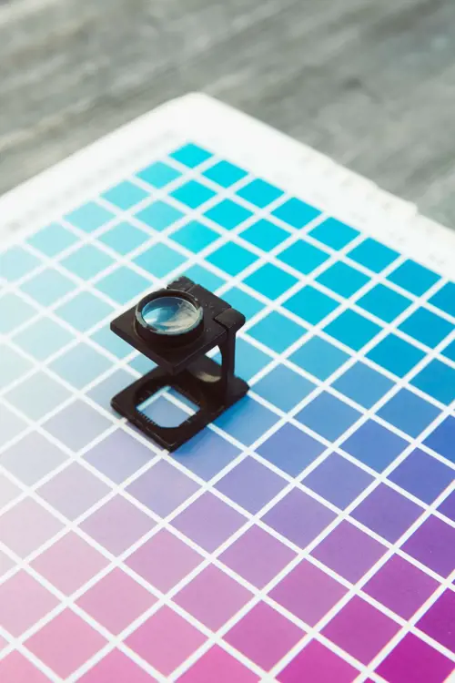 a black magnifying glass on a color chart
