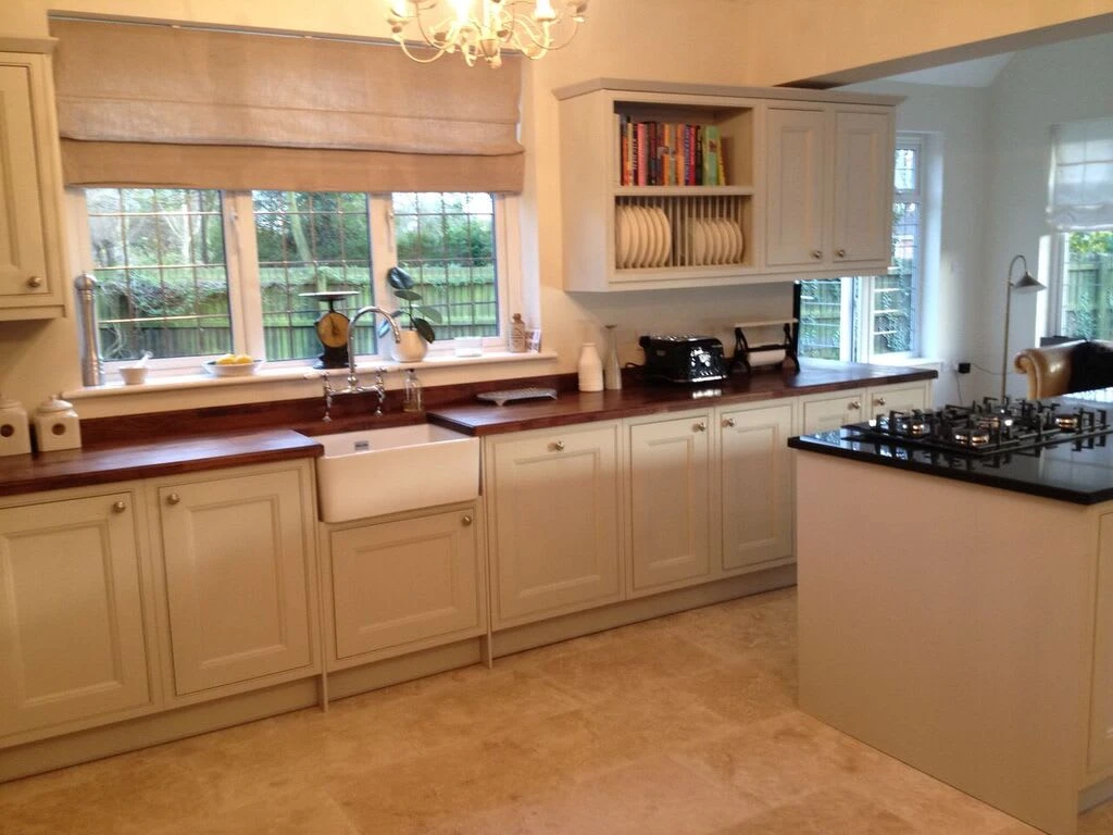 a kitchen with white cabinets and a chandelier