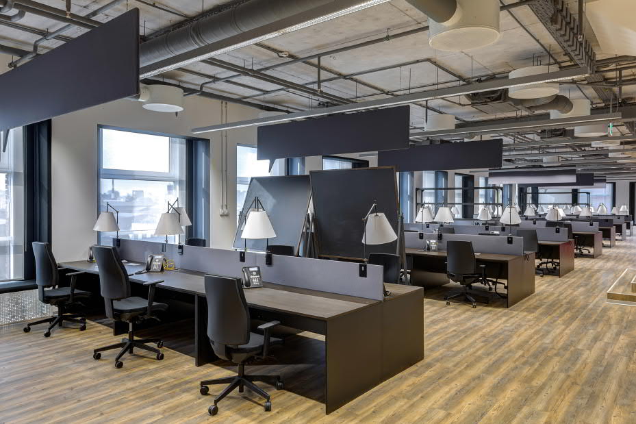 an office with black chairs and tables