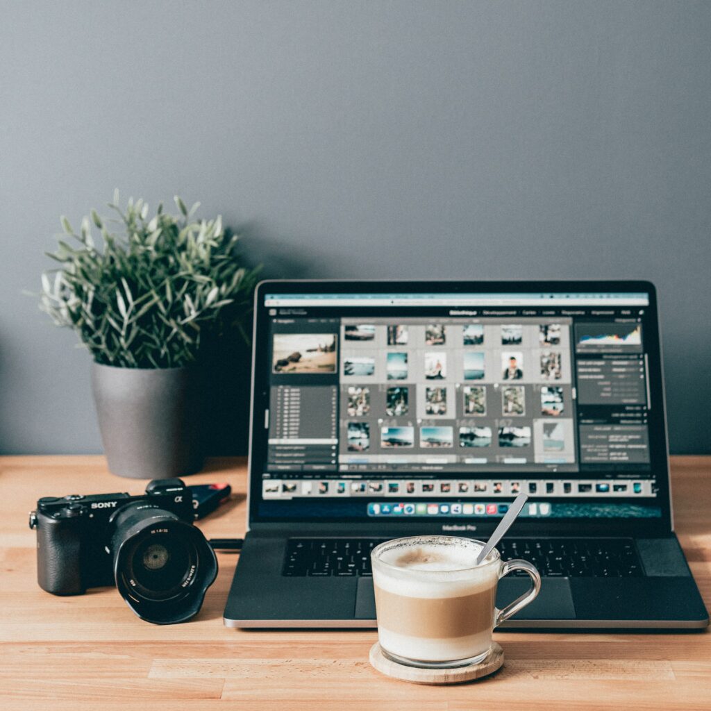 a laptop and a cup of coffee on a table