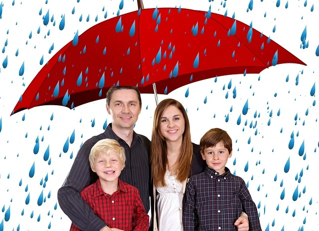 a family standing under an umbrella