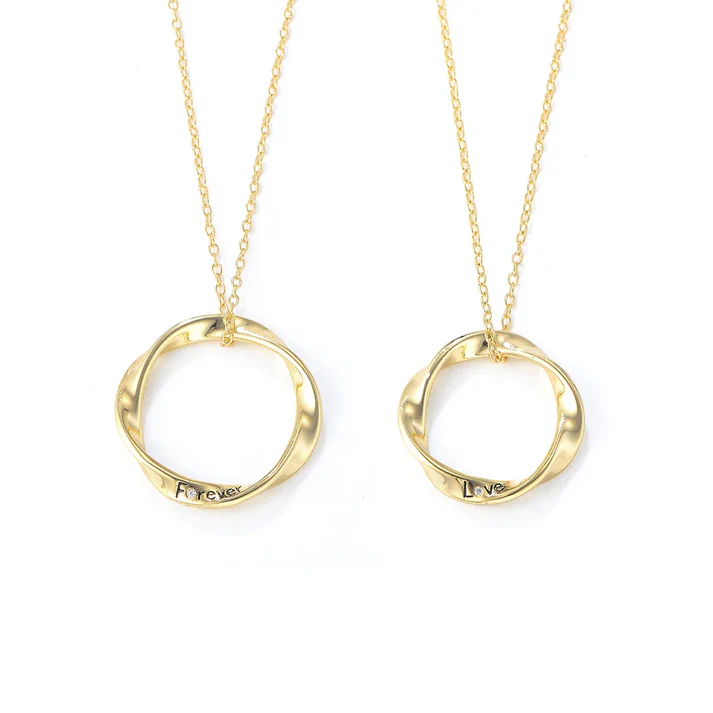 a pair of gold necklaces with a couple of circles