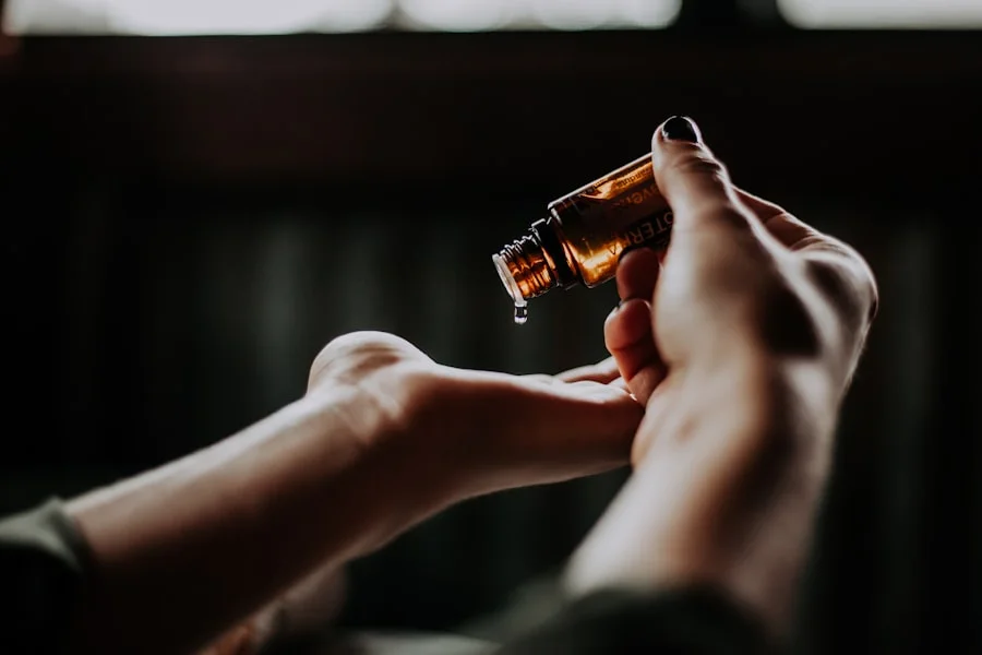 a person pouring a drop of liquid onto a hand
