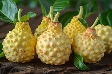 a group of yellow fruit with green leaves