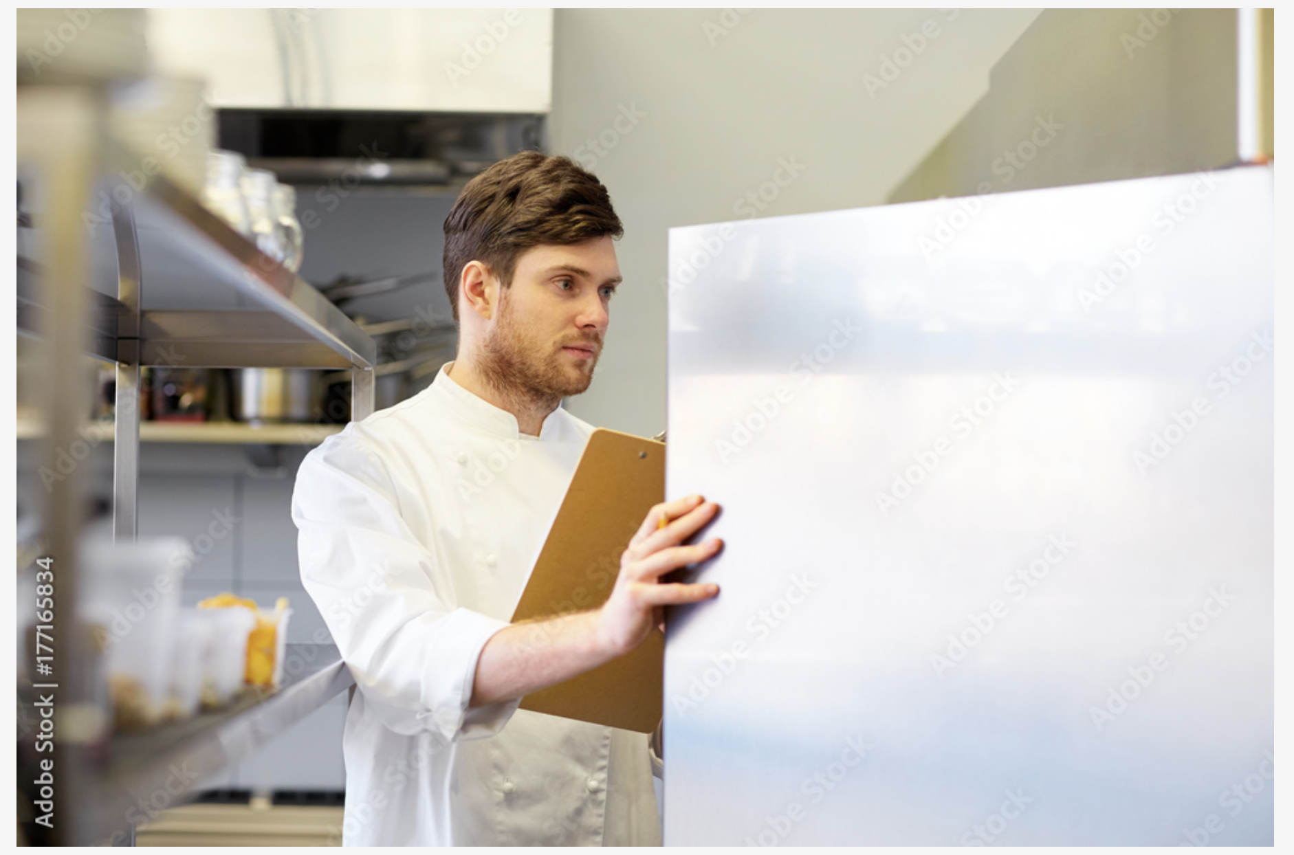 a man in a chef's uniform holding a clipboard