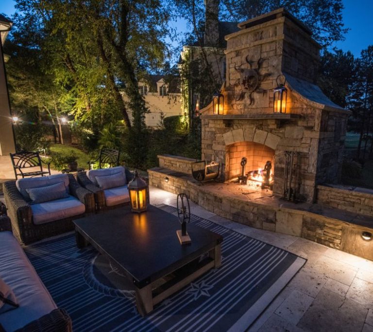 a patio with a fireplace and a table