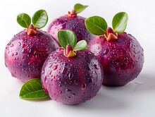 a group of purple fruit with green leaves