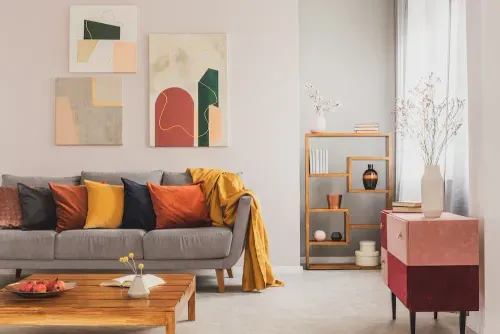 a living room with a couch and art on the wall