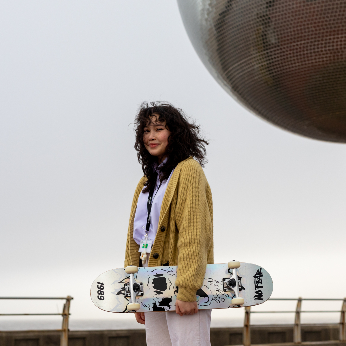 a woman holding a skateboard