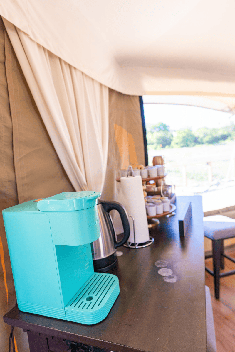 a blue coffee maker on a table