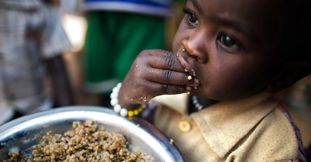 a child eating food from a bowl