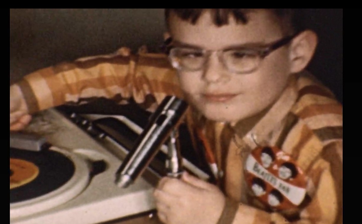 a boy holding a microphone