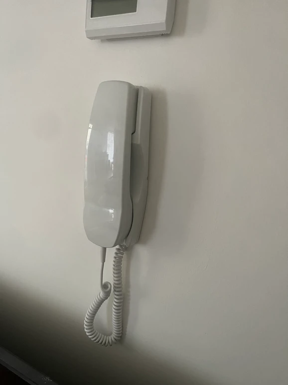 a white telephone on a wall