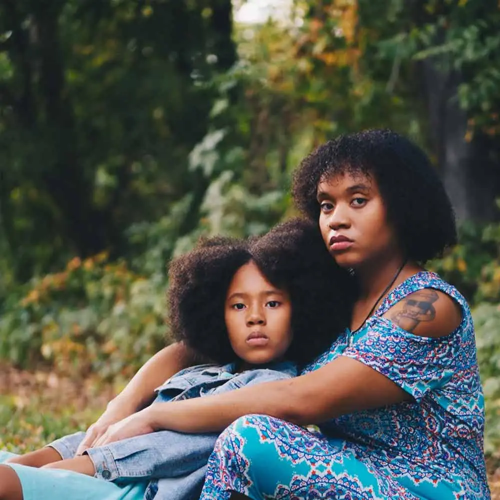 a woman and a child sitting on the ground