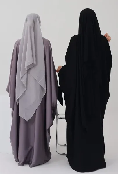 two women wearing black and purple robes