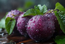 a group of purple plums with water droplets on them