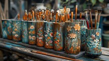 a group of paint brushes in a vase