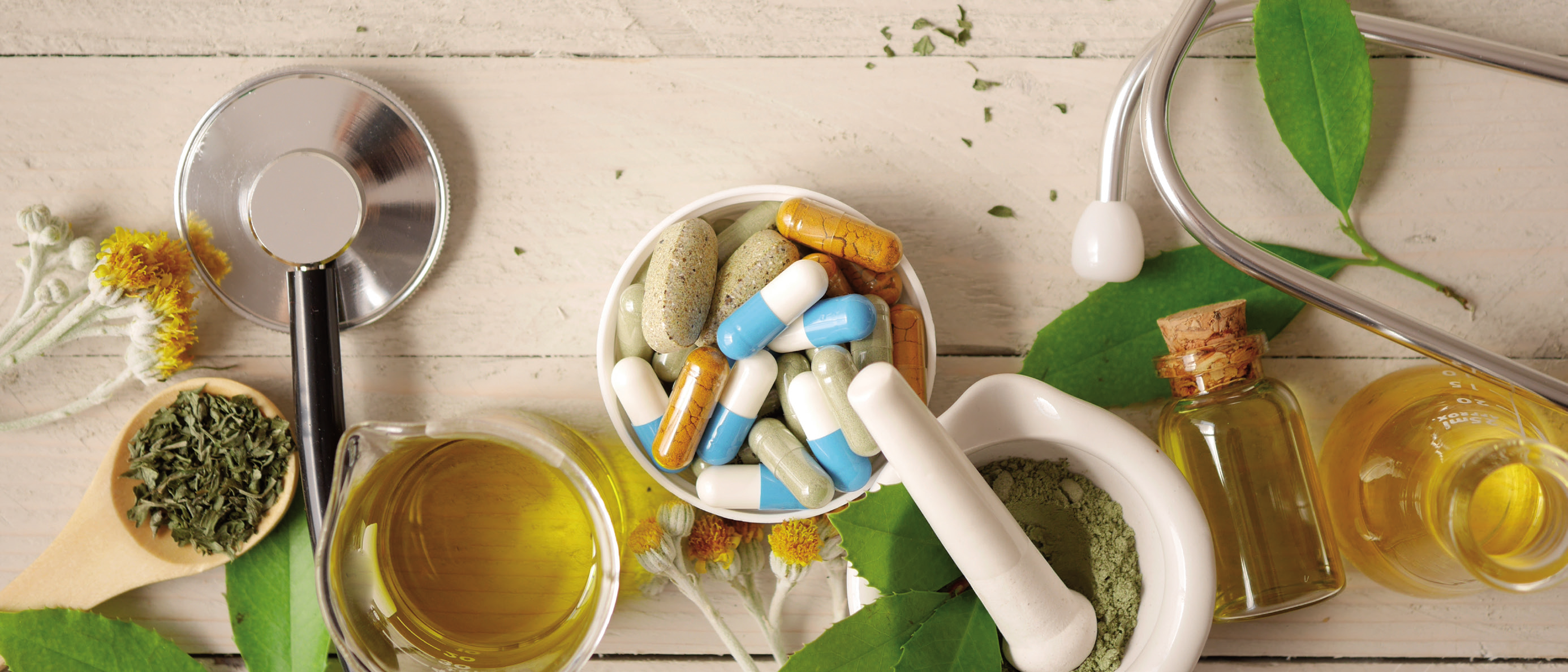 a mortar and pestle with pills and herbs