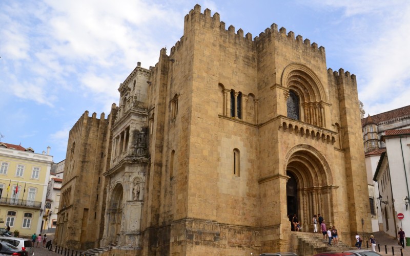 a stone building with people walking up the stairs