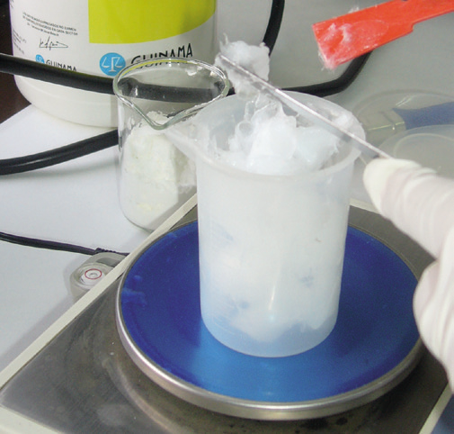 a person holding a beaker with ice