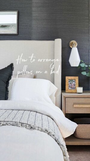 a bed with a white headboard and a lamp
