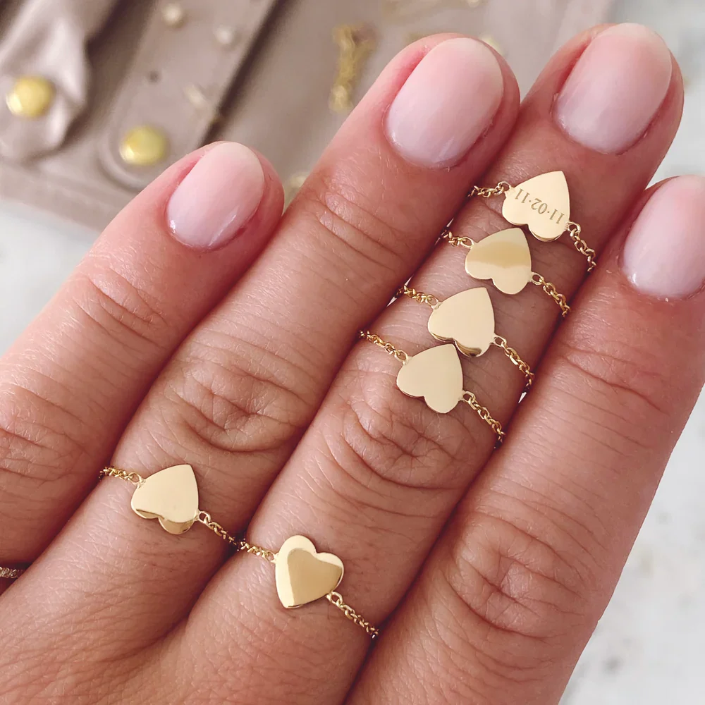 a hand with gold heart rings
