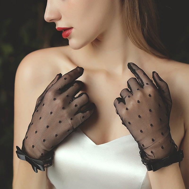 a woman wearing black gloves