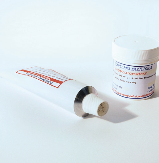 a tube of cream next to a container