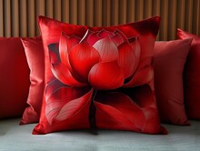 a red pillow with a flower on it