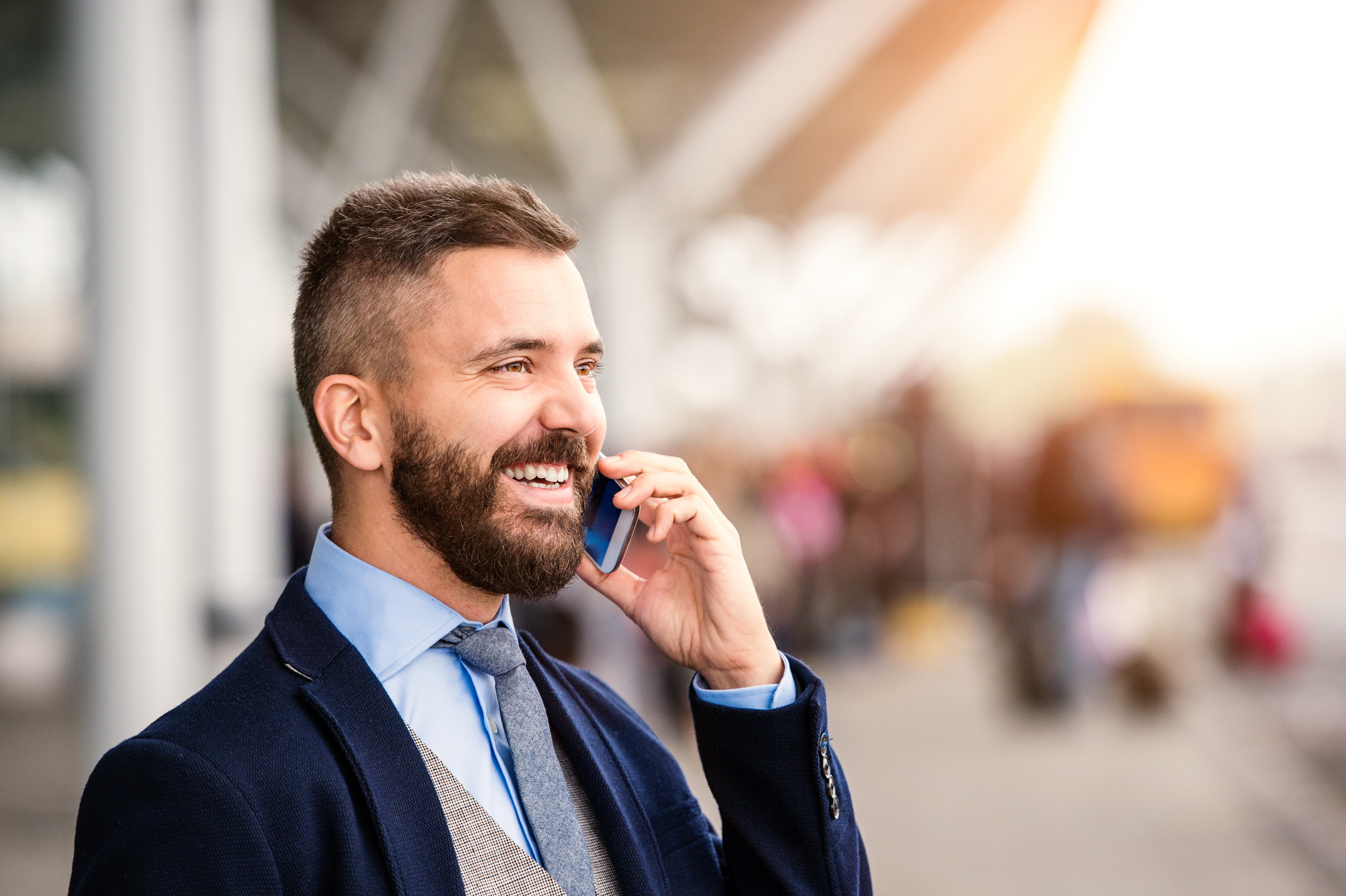 a man in a suit talking on a cell phone