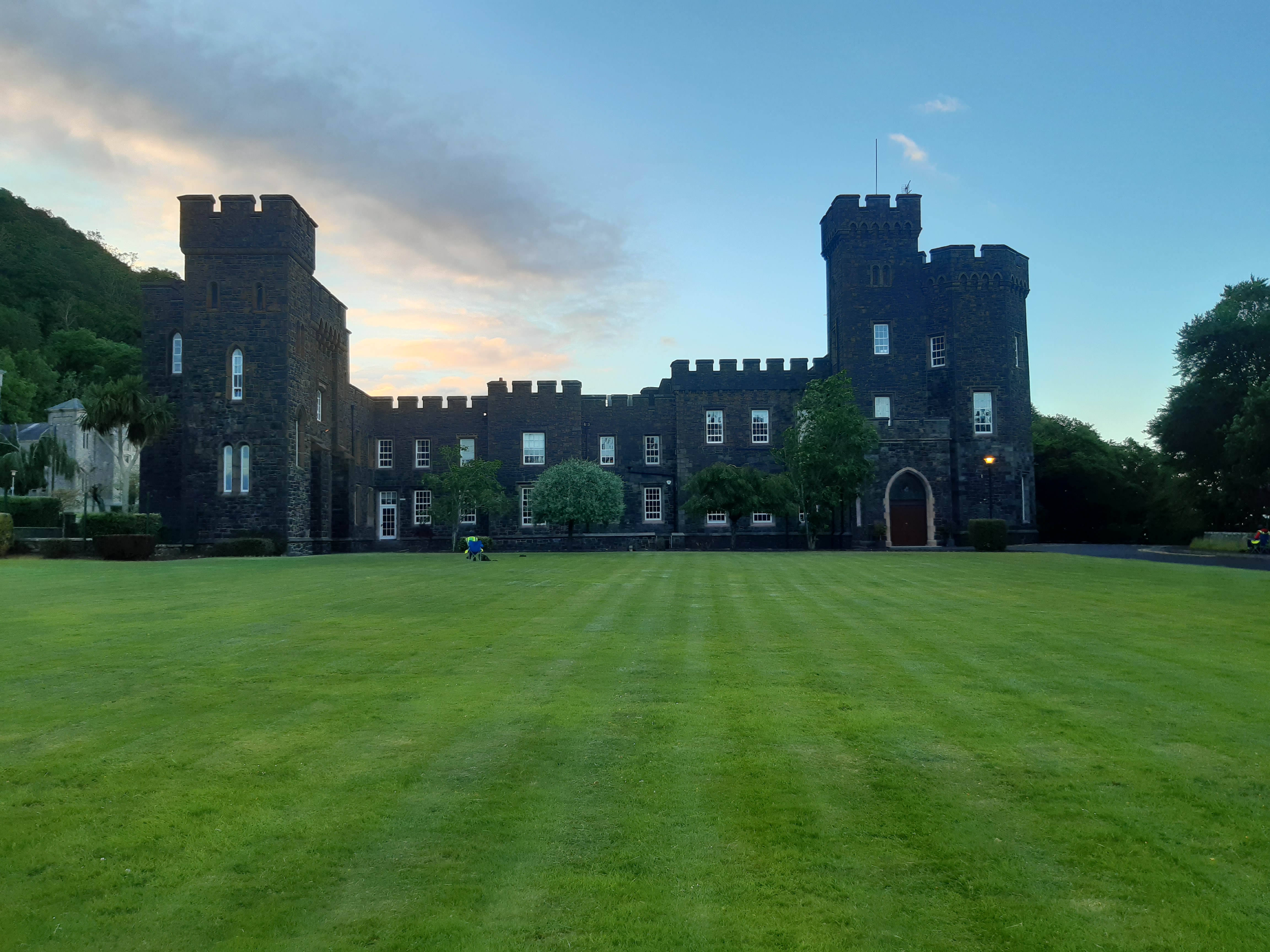 a large lawn with a castle in the background