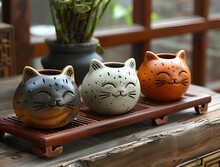 a group of cat shaped vases