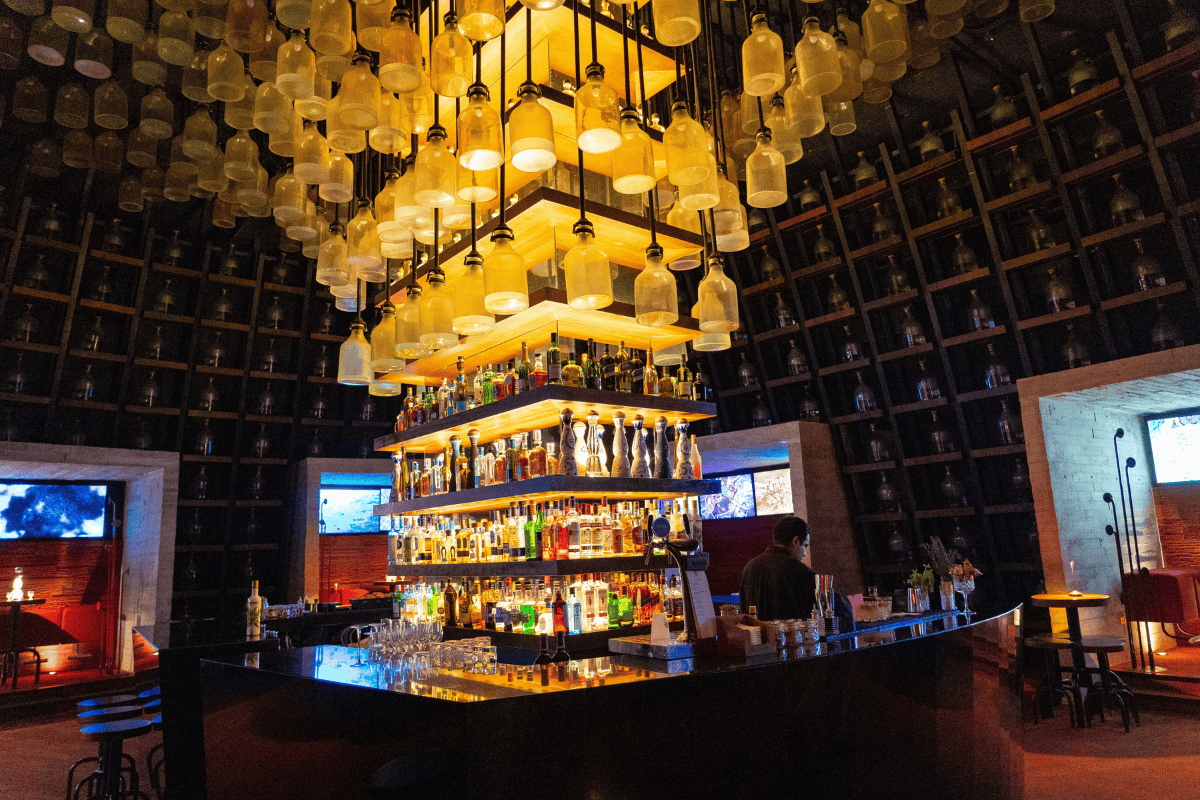 a bar with many bottles from the ceiling