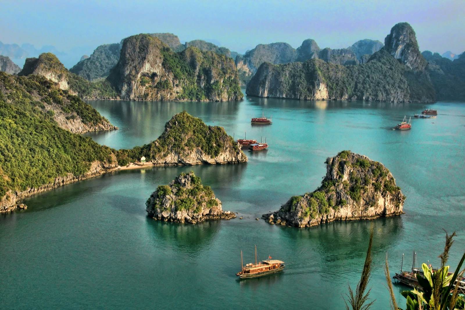 boats in the water with islands with Ha Long Bay in the background
